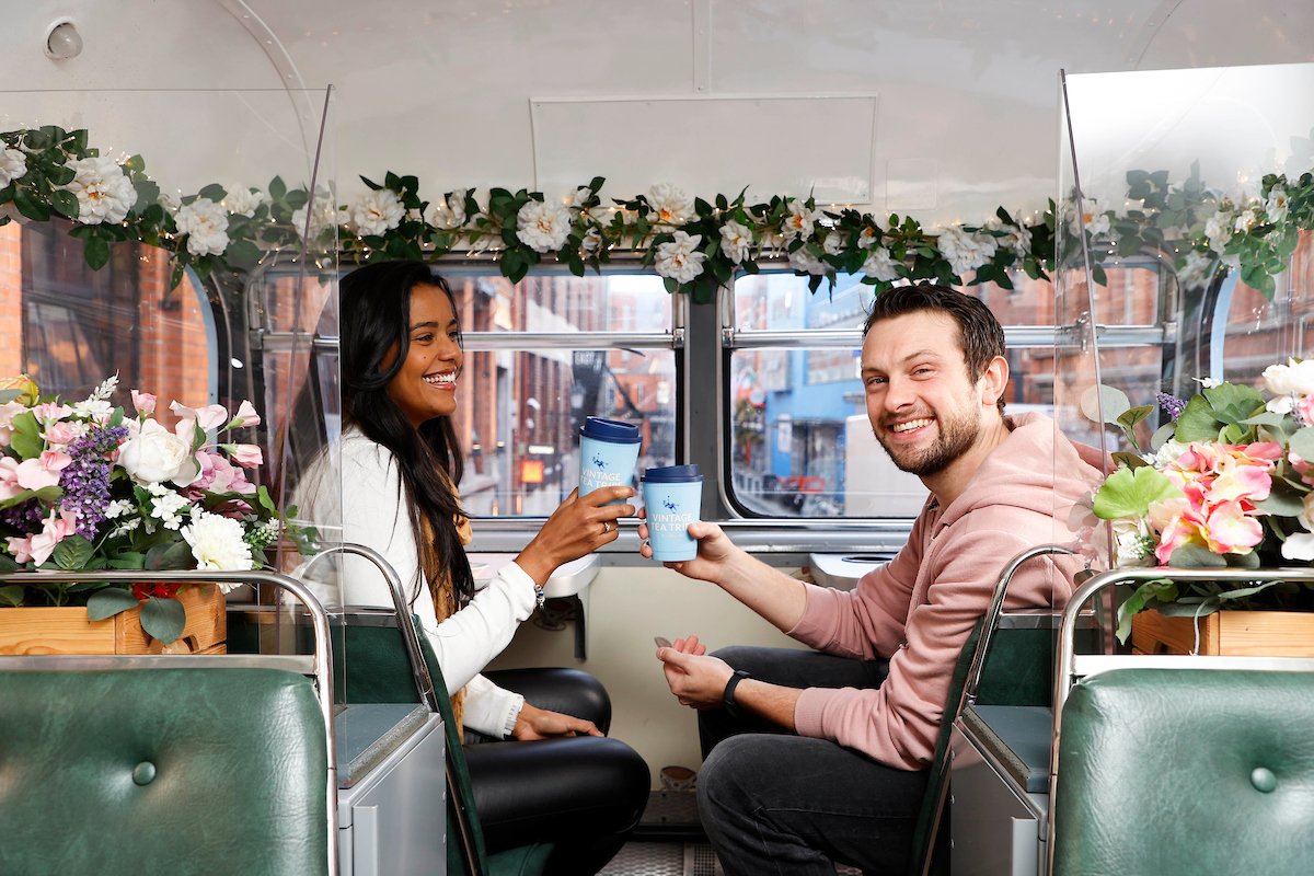 man and woman with coffee cups